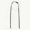 Choker necklace with a thin silver chain and long black ribbon ties against a pale background.