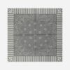 Gray square bandana laid flat, showing a paisley border and striped edges with corner logos, and a central floral motif.
