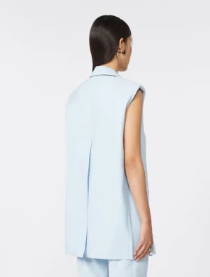 Back view of a woman wearing a light blue sleeveless vest with a collar, paired with matching pants.