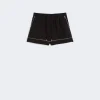 Black athletic shorts with white piping along the seams, front view on a light background