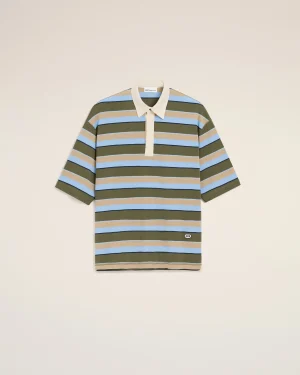 Striped polo shirt on a hanger against a light beige background; olive green, blue, and tan stripes with a cream collar and placket, centered in frame.
