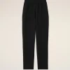 Black pants with an elastic waistband, full-length, shown against a light beige background (informative product image).