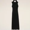 Long black sleeveless dress with a draped scarf around the neck, displayed against a light beige background.