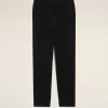 Full-length image of black jogger-style pants with an elastic drawstring waist against a light beige background, displayed front-on for product viewing.