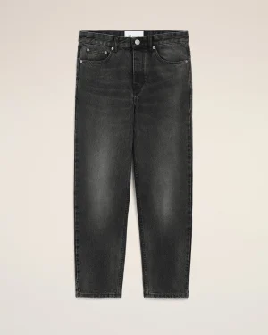 Dark wash jeans laid flat, showing waistband, front pockets, and zipper area against a light background.
