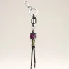 Silver keyring with a black leather cord and colorful beads hanging below (purple and lime).