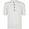 White short-sleeve knit polo with a collar and four brown buttons down the placket