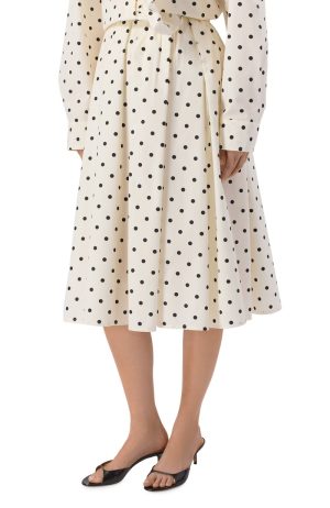 Cream midi dress with black polka dots, tied waist, shown with black heeled sandals.