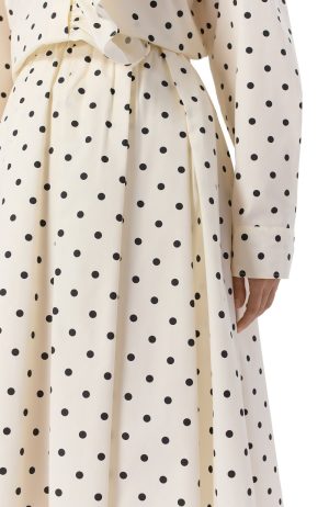 Cream polka-dot dress with a tied waist, close-up of the waist and sleeve showing the pattern