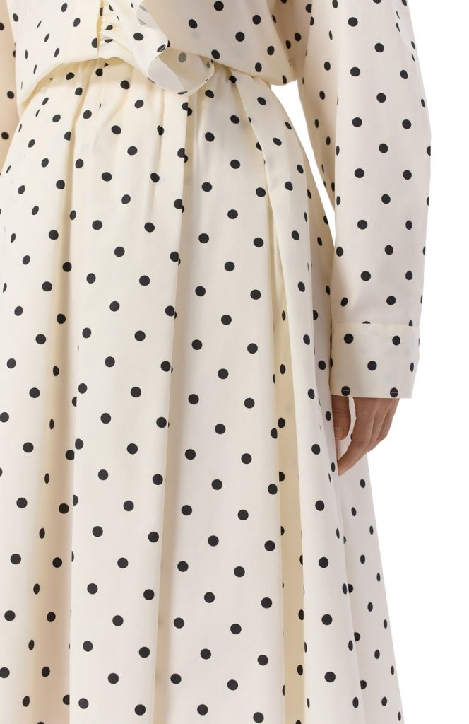 Cream polka-dot dress with a tied waist, close-up of the waist and sleeve showing the pattern