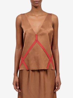 Brown satin sleeveless top with a sheer V-neck and red geometric strap detailing.