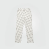 White pants with evenly spaced black polka dots on a light background, full-length and straight-leg fit.