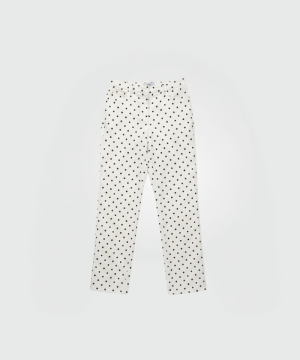 White pants with evenly spaced black polka dots on a light background, full-length and straight-leg fit.