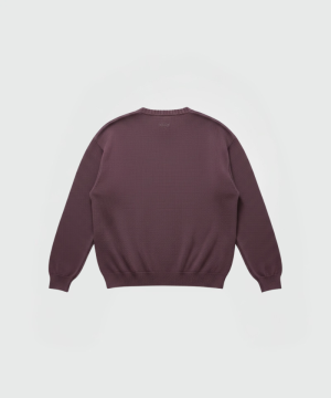 Back view of a burgundy knit crewneck sweatshirt with ribbed cuffs and hem, subtle MSGM branding near the neckline.