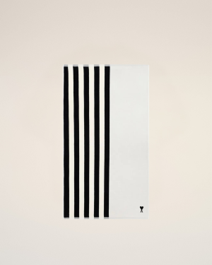Abstract white card with several bold black vertical stripes along the left edge, placed on a pale beige background, with a small X mark bottom-right.