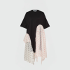 Black oversized T-shirt with attached sheer polka-dot scarves draped at the sides in white with pink dots and gray with black dots.
