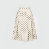 Cream midi skirt with black polka dots and an elastic waistband, full and flowy.