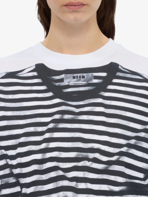 Close-up of a white striped T-shirt with a label reading 'MSGM Milano Made in Italy' at the chest.