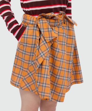 Orange plaid wrap skirt with a tied belt, paired with a burgundy and white striped sweater.