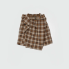 Brown and beige plaid wrap skirt with a belt at the waist.