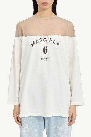 Off-shoulder white top with sheer yoke and printed 'MARGIELA 6 EST 1997' on front.