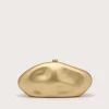 Gold-toned, abstract organic sculpture on a light beige background with soft shadows.