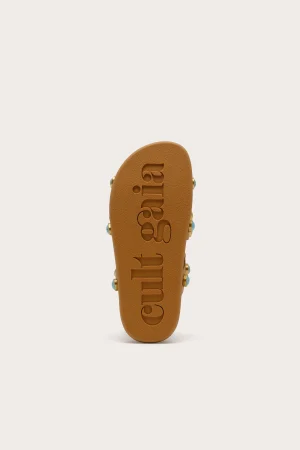 Top-down view of a brown slide sandal with embossed lettering along the footbed in the center