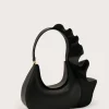Black leather handbag with a large circular handle and sculpted wavy top edge.
