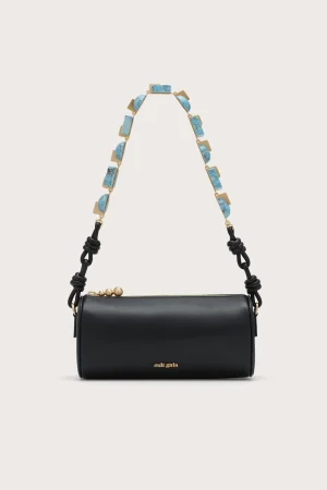 Black leather crossbody/shoulder bag with a turquoise stone chain strap and gold hardware, Cult Gaia logo visible at the bottom edge.
