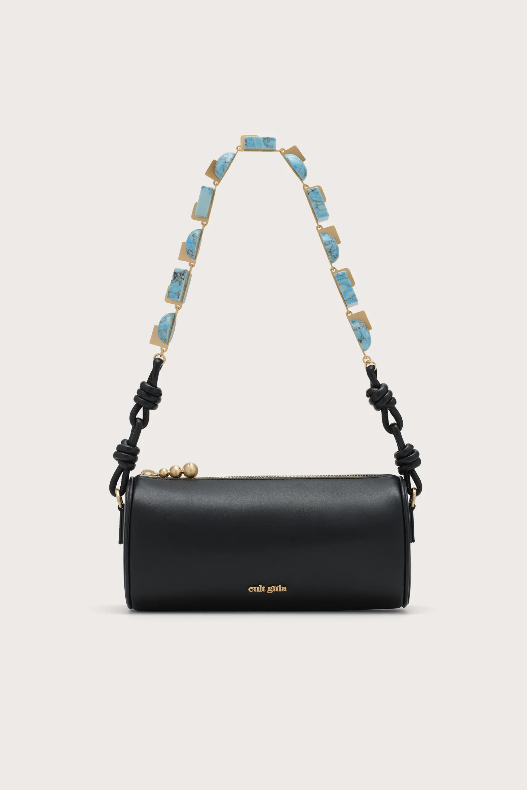 Black leather crossbody/shoulder bag with a turquoise stone chain strap and gold hardware, Cult Gaia logo visible at the bottom edge.