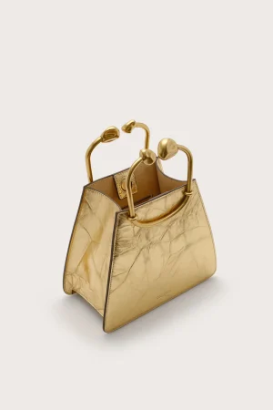Gold metallic handbag with rounded top handles, structured leather design and subtle stitching detail.