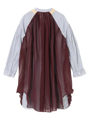 Layered garment: sheer burgundy overlay over a light blue striped shirt with yellow shoulder patches.