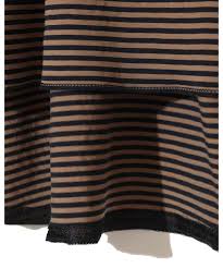 Close-up of brown and black horizontal striped knit fabric with a folded hem at the bottom.