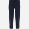 Dark navy pants with belt loops and front pockets, button-and-zip fly.