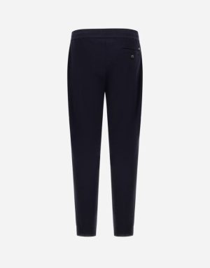 Navy dress pants viewed from the back, showing a single back pocket with a button.