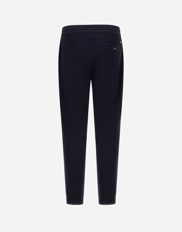 Navy dress pants viewed from the back, showing a single back pocket with a button.