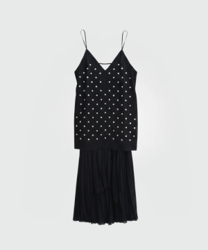 Black sleeveless dress with pearl embellishments, V-neck and spaghetti straps, paired with a sheer, layered skirt.