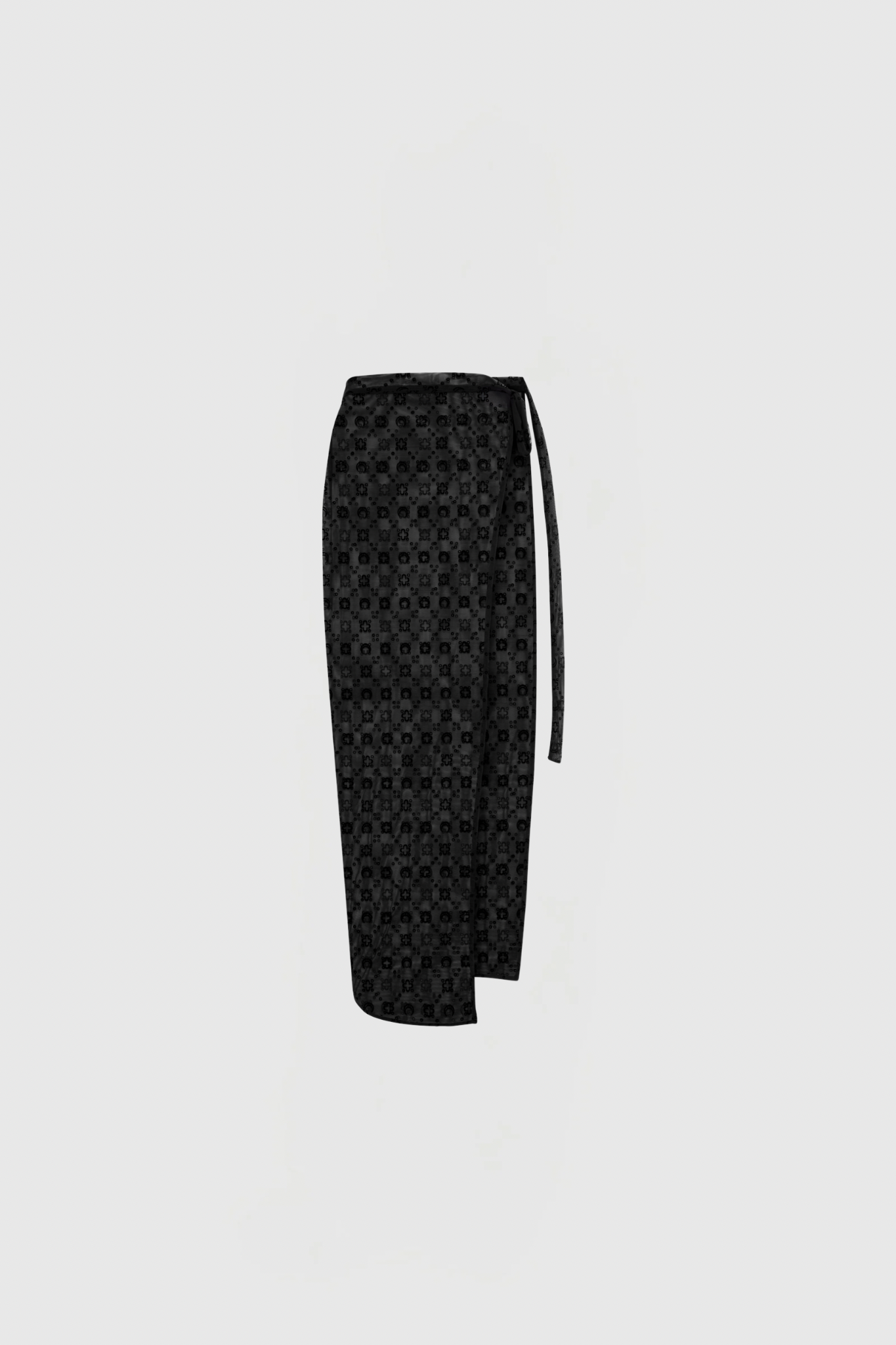 Black tie with a small circular pattern, hanging against a pale gray background (cropped at the bottom).