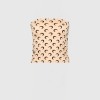Beige upholstered chair with a repeating black crescent moon pattern.