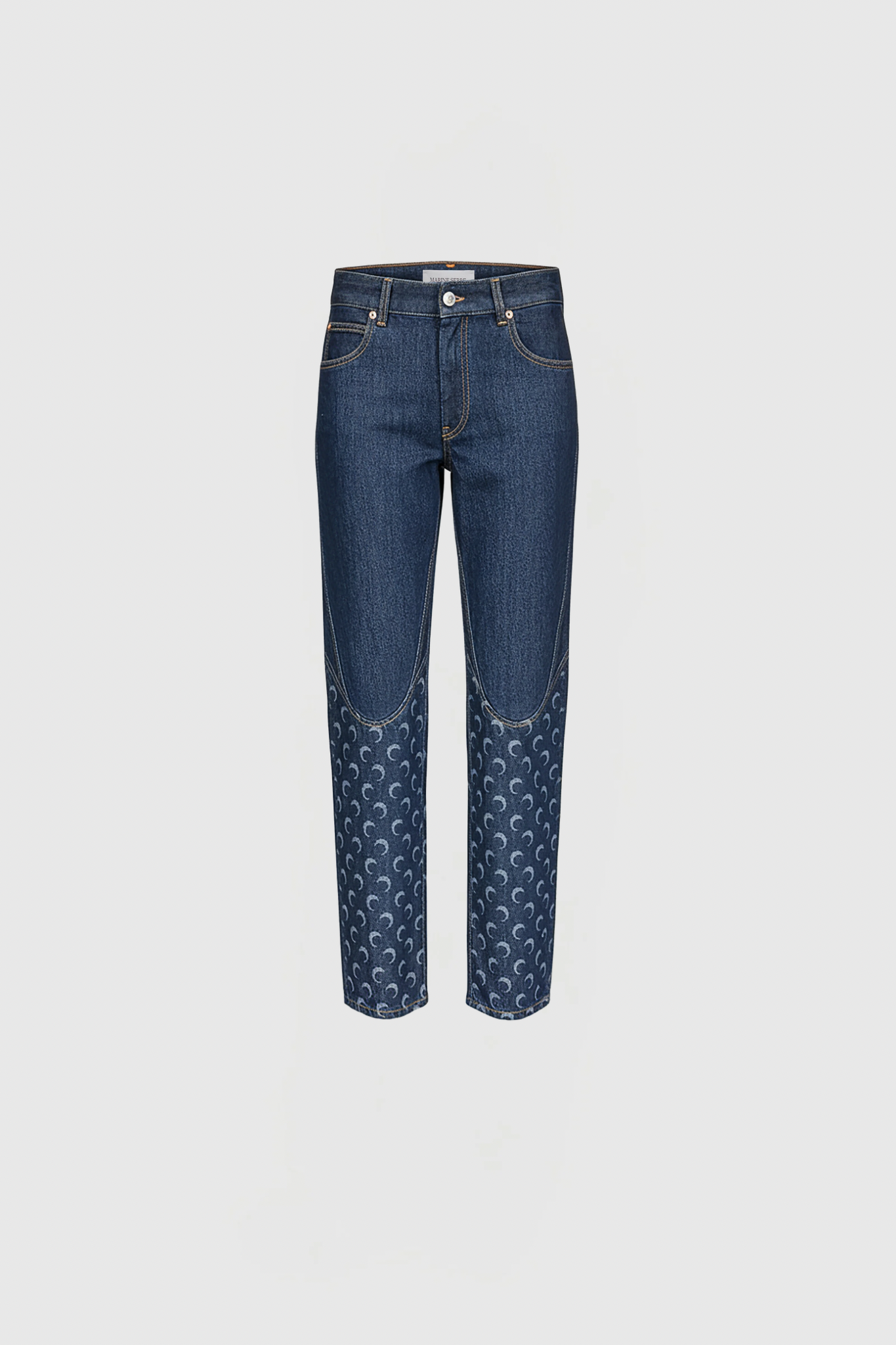 Blue denim jeans with a decorative crescent pattern along the lower legs, front view.