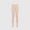 Light pink leggings with a black crescent pattern worn on a mannequin against a pale background, from waist to ankles.