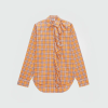 Orange plaid blouse with ruffle front placket and bow tie detailing, long sleeves, curved hem (informative fashion image).