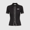 Black short-sleeve polo dress with white piping along the front placket and sleeve hems; Marine Serre label visible on chest