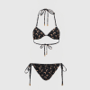 Black string bikini with peach crescent moon pattern, triangle top with tie straps and matching side-tie bottoms.