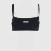 Black ribbed crop top with thin spaghetti straps on a mannequin, featuring a small Marine Serre label at center.