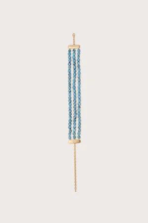 A gold-tone necklace with three strands of small blue beads and a gold clasp at the top and bottom.
