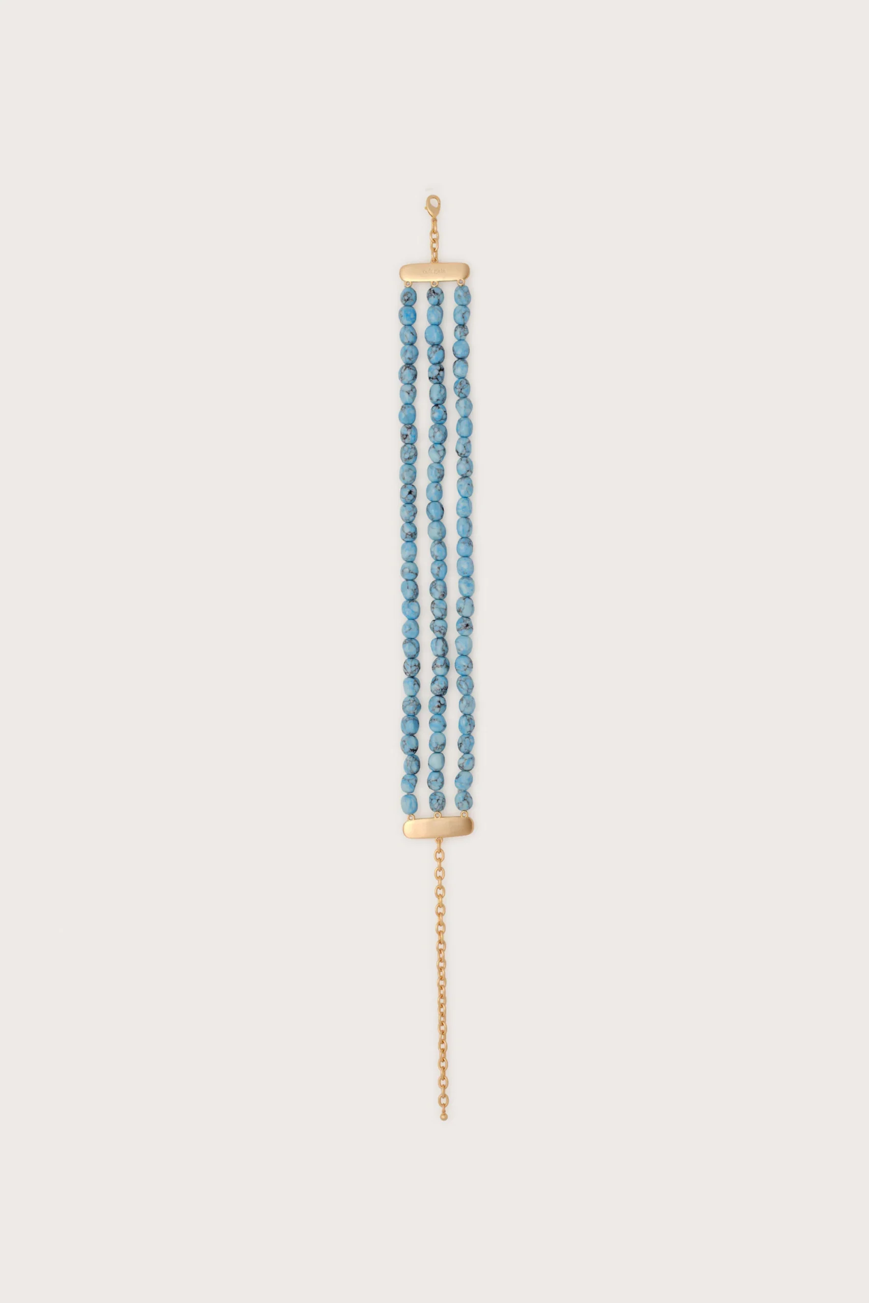 A gold-tone necklace with three strands of small blue beads and a gold clasp at the top and bottom.