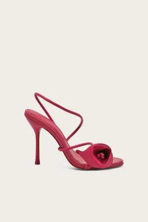Bright pink high-heeled sandal with thin straps and a decorative knot at the toe area.