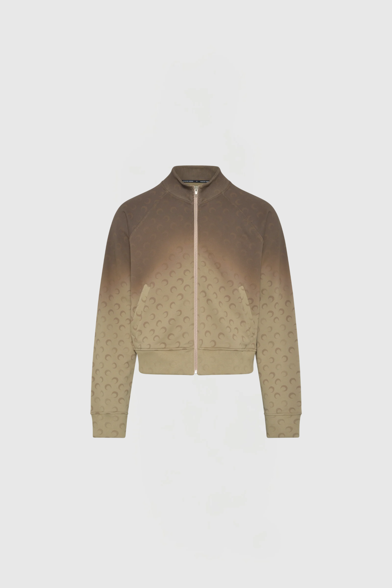 Brown gradient zip-up jacket shown from the front, with a pale zipper, ribbed cuffs, and a subtle repeating pattern across the fabric.