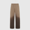 Beige trousers with a repeating brown crescent pattern shown from the waist to the lower legs against a light background.